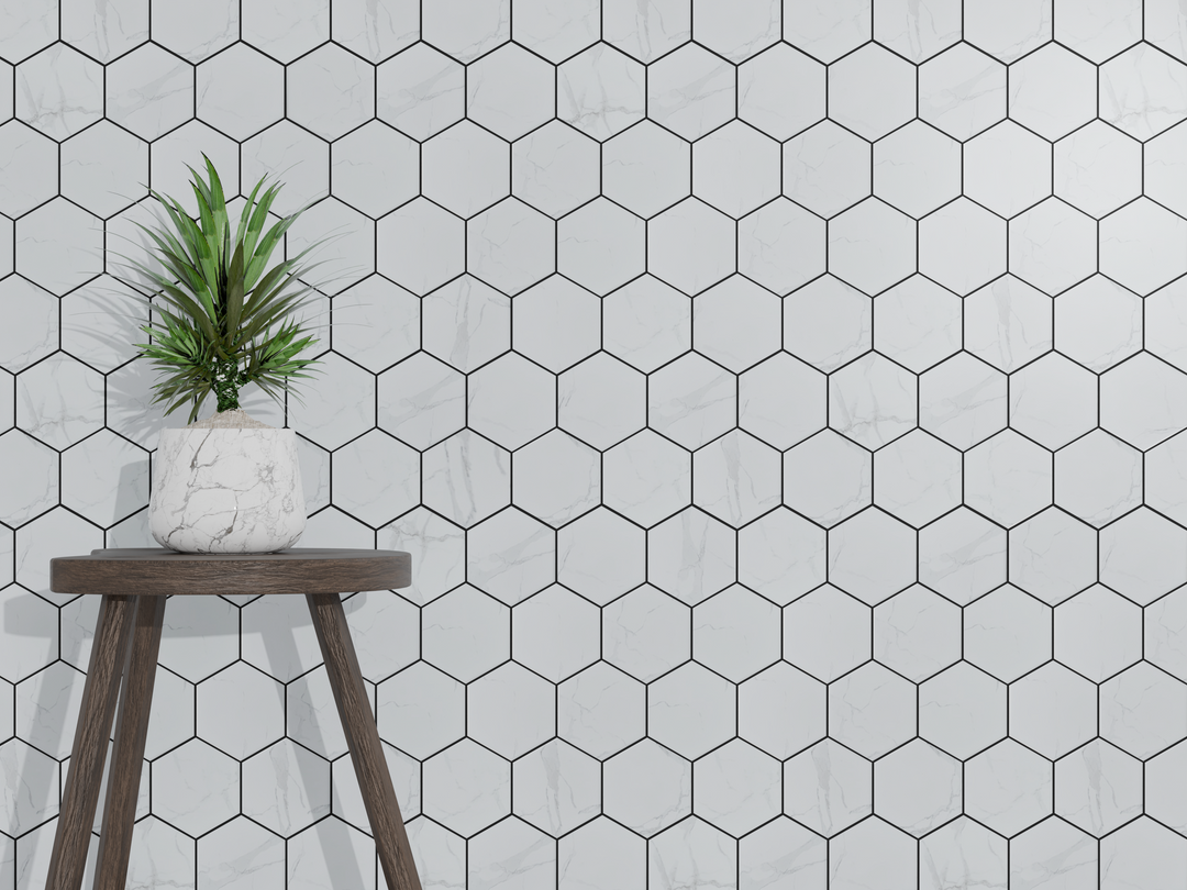 Living room accent wall with 4-in Hexagon Statuario Satin Porcelain Mosaic Tile – geometric satin finish porcelain design.