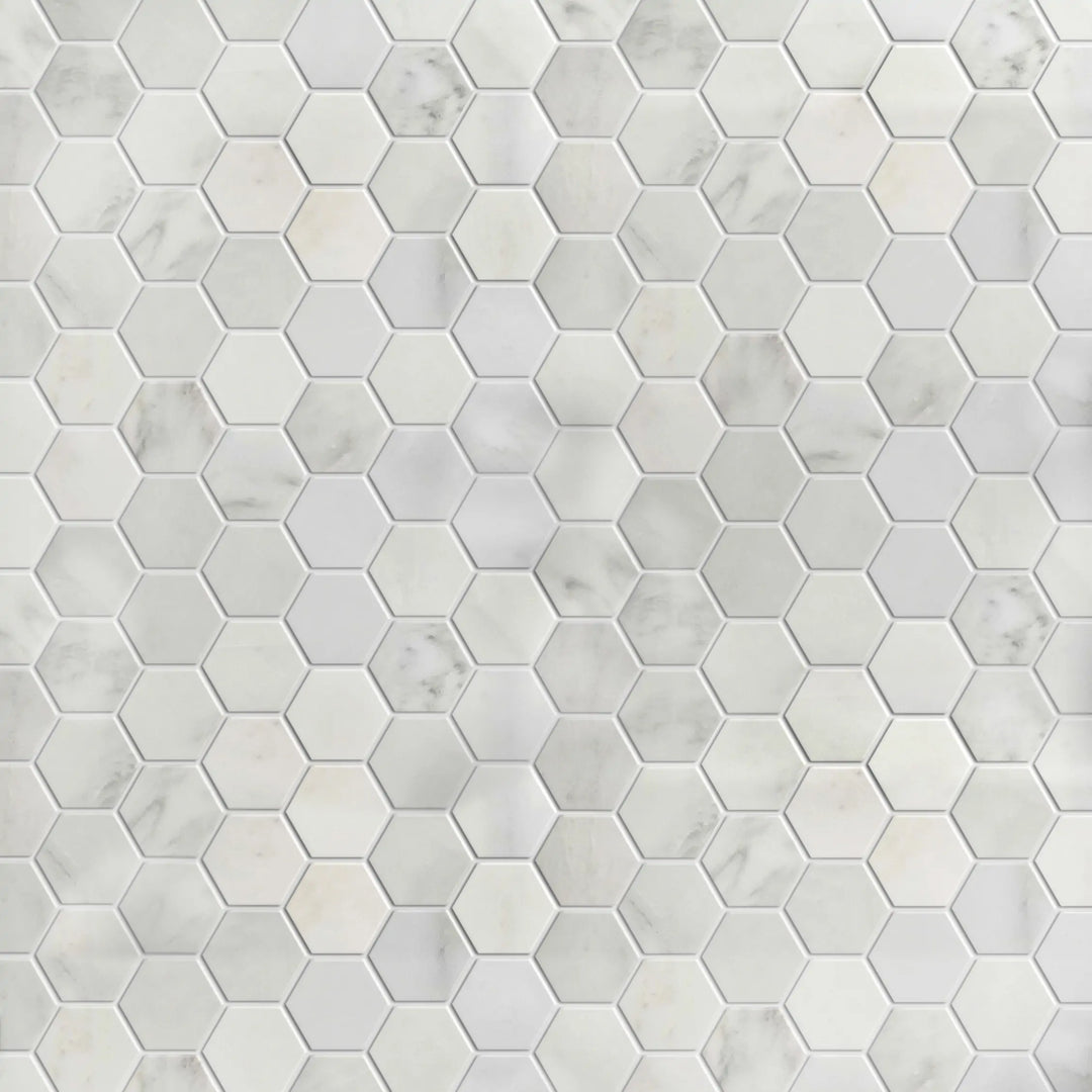 Display board of Calacatta 2-inch polished marble hex mosaic – showroom layout with white and gold tones
