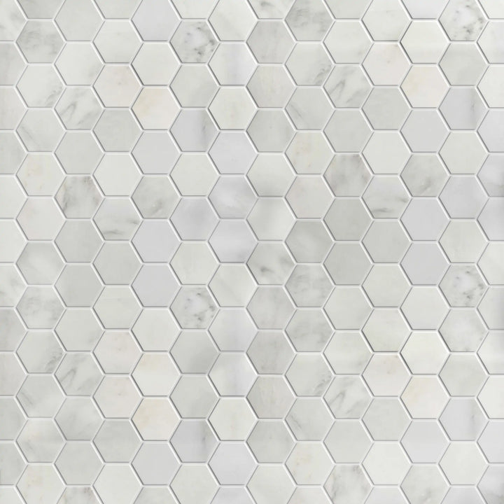 Display board of Calacatta 2-inch polished marble hex mosaic – showroom layout with white and gold tones