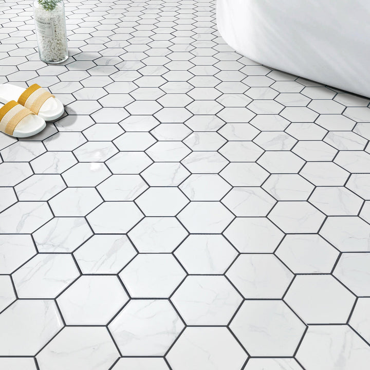 Bathroom wall and floor with 4-in Hexagon Statuario Satin Porcelain Mosaic Tile – satin finish porcelain mosaic design.
